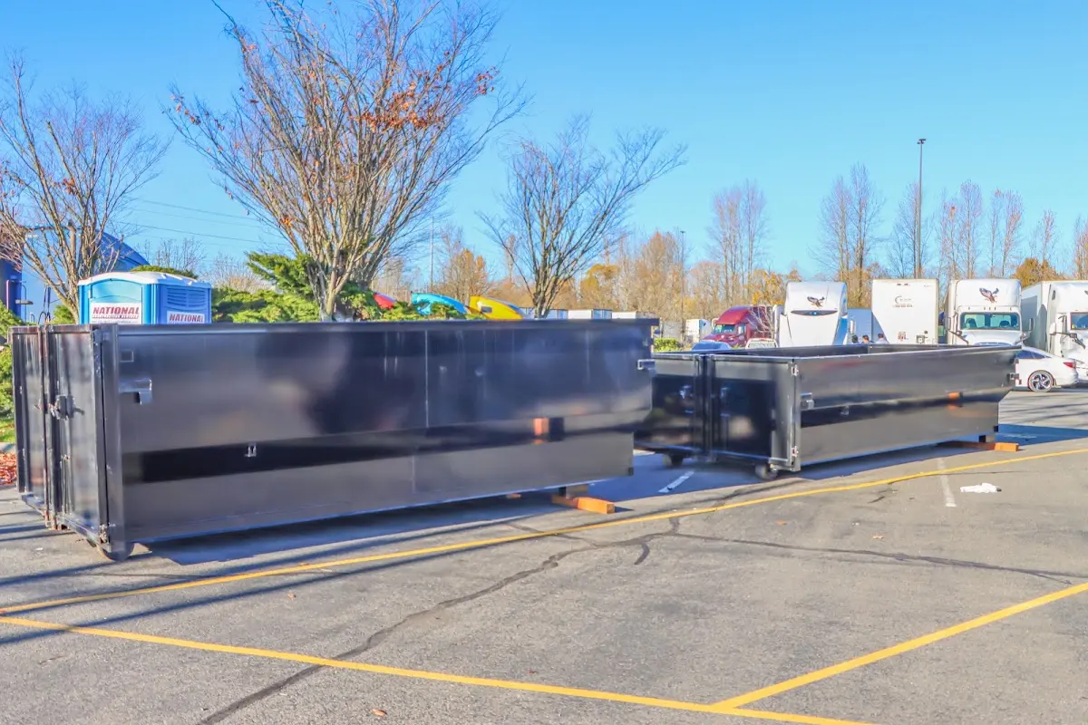 Professional dumpster rental service with roll-off container on residential driveway in Macon-Bibb County